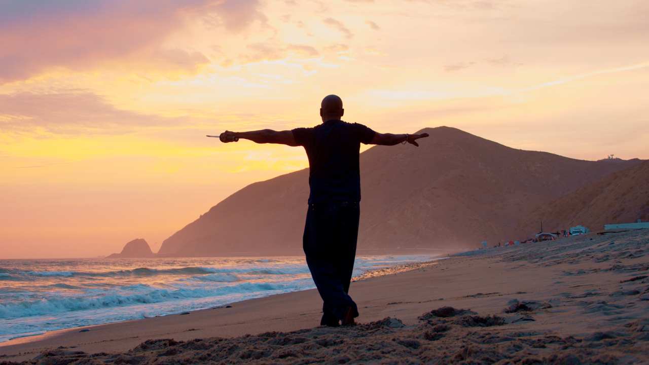 silhouette of a man on a beach at sunrise
